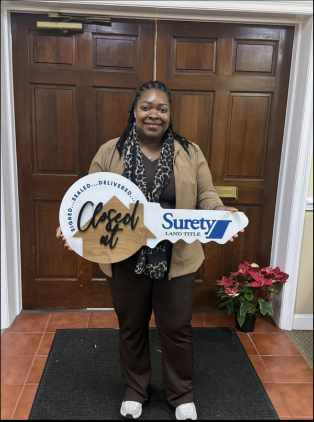 Homeowner smiles holding key prop